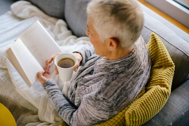 istock Woman reading book and drinking coffee 904905934