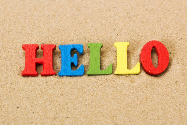 istock Word hello of colored wooden letters on sandy beach 904906396