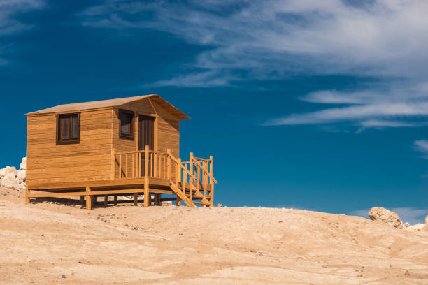 Small wooden bathing house on a white sandy beach