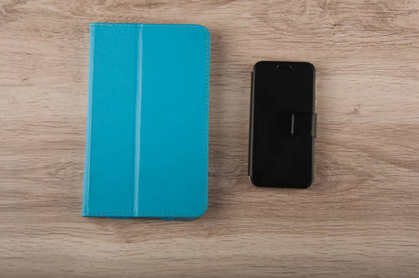 istock digital tablet and smart phone in covers lay on table 904916308