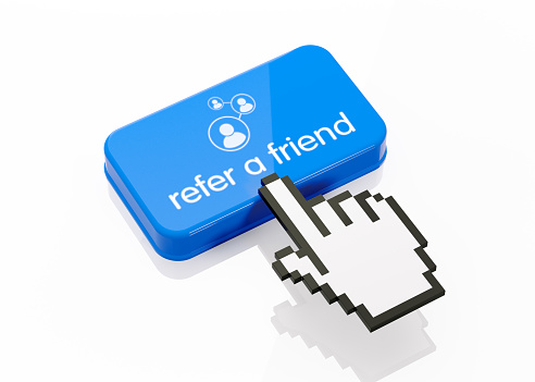 Hand shaped computer cursor is clicking on a blue computer button on white reflective surface. Refer a friend writes on button. Horizontal composition with copy space and clipping path. Social media concept.
