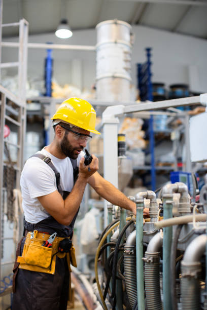 istock Worker in factory using walkie talkie 904919388
