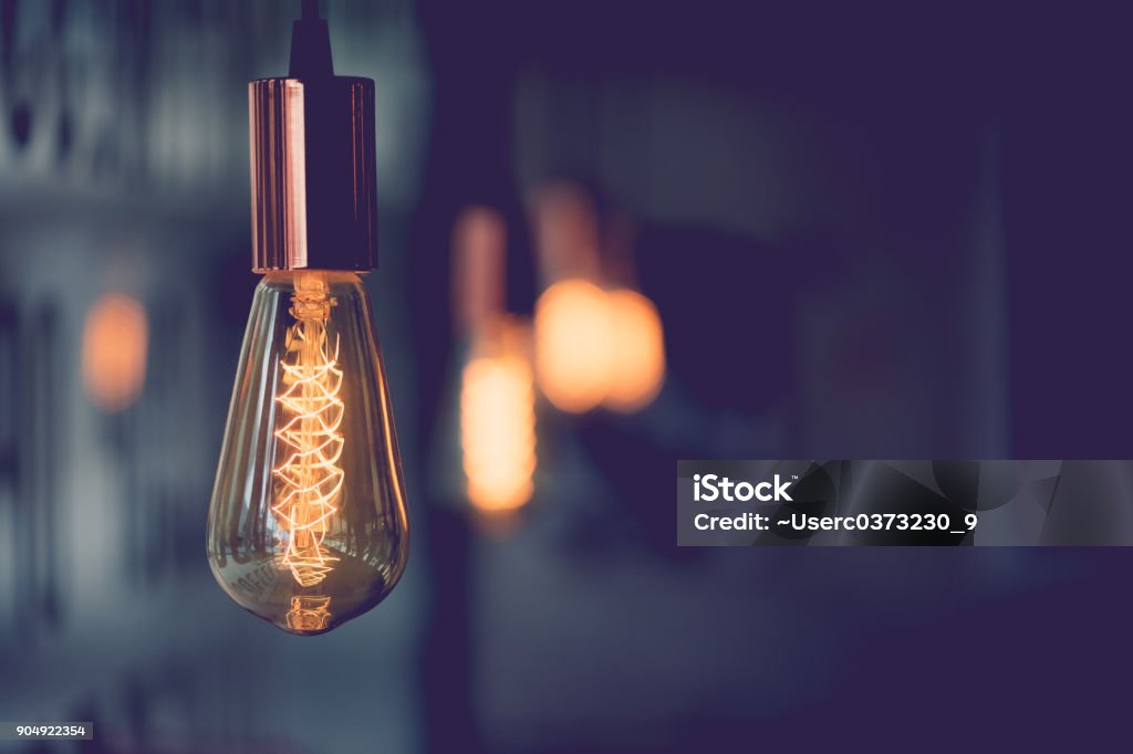 Vintage electric light.Decorative antique edison style light bulbs in coffee shop.vintage tone Edison Light Bulb Stock Photo