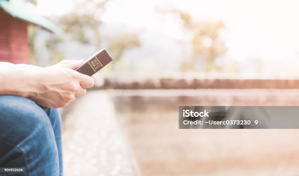 Holy bible,Teenager man holding Holy bible ready for read and have relationship with god faith, spirituality and religion concept. Bible Stock Photo