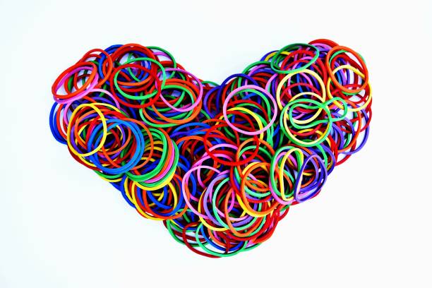 istock heart shape of colorful rubber ring on white paper background 904923110