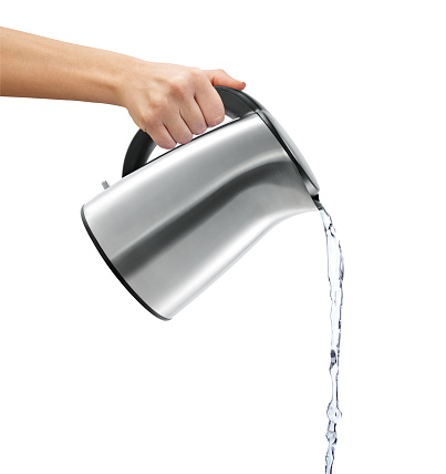 Woman pouring water from kettle on white background