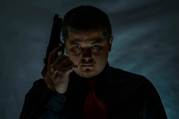 istock The criminal holds a gun in his hand. Crime. 904926116