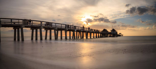 istock Naples Pier on the beach at sunset 904926286