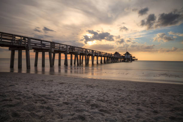istock Naples Pier on the beach at sunset 904926294