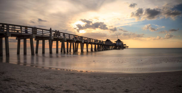 istock Naples Pier on the beach at sunset 904926296