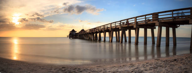 istock Naples Pier on the beach at sunset 904926340