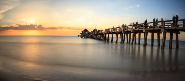 istock Naples Pier on the beach at sunset 904926344