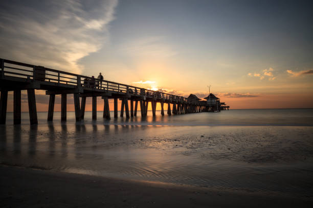 istock Naples Pier on the beach at sunset 904926418