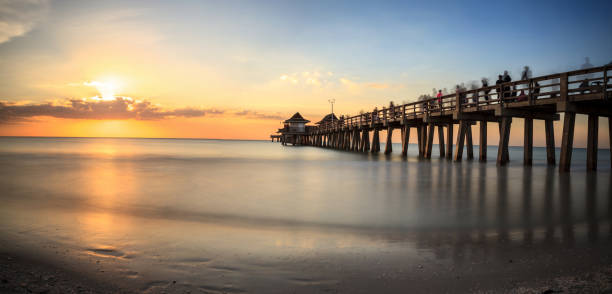istock Naples Pier on the beach at sunset 904926420