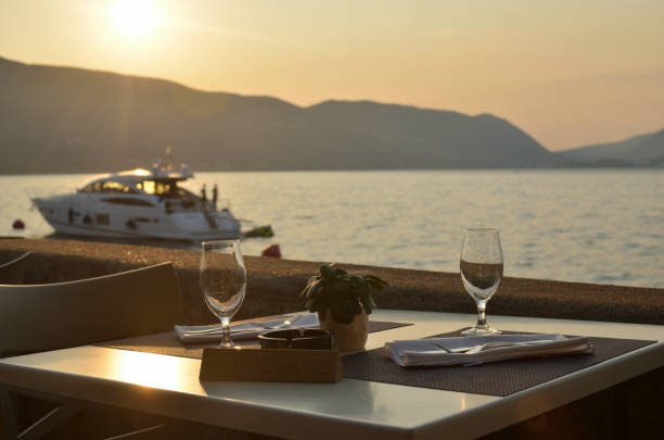 istock Wine glasses on table with sea view 904928476