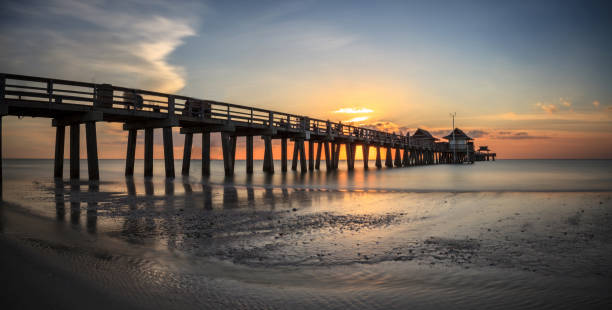 istock Naples Pier on the beach at sunset 904928482