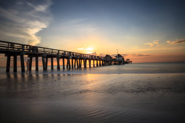 istock Naples Pier on the beach at sunset 904928712