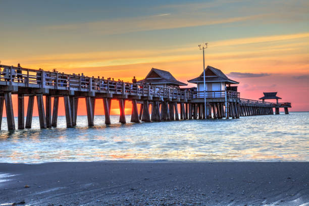 istock Naples Pier on the beach at sunset 904928944