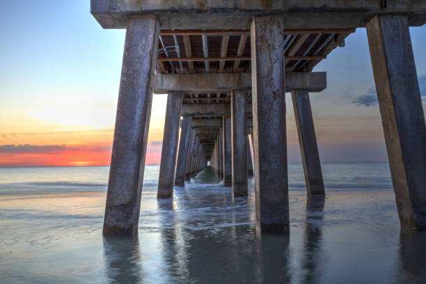 istock On the beach under the Naples Pier at sunset 904929092
