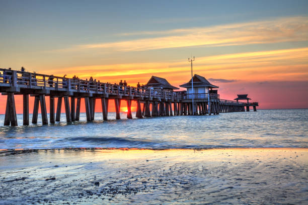 istock Naples Pier on the beach at sunset 904929094