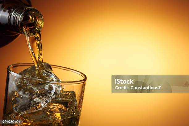Pouring Whiskey Stock Photo - Download Image Now - Alcohol - Drink, Bar - Drink Establishment, Bottle