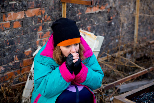 A portrait of a homeless hungry woman