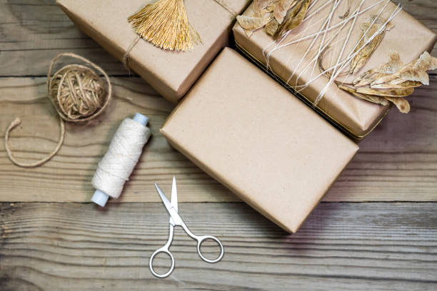 istock Gift box handmade from white paper, dry twigs, spruce. 904938496