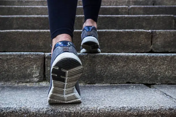 Photo of Morning jogging young woman outdoors.