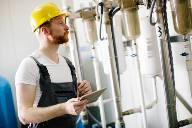 istock Young male engineer wearing helmet in factory 904956984