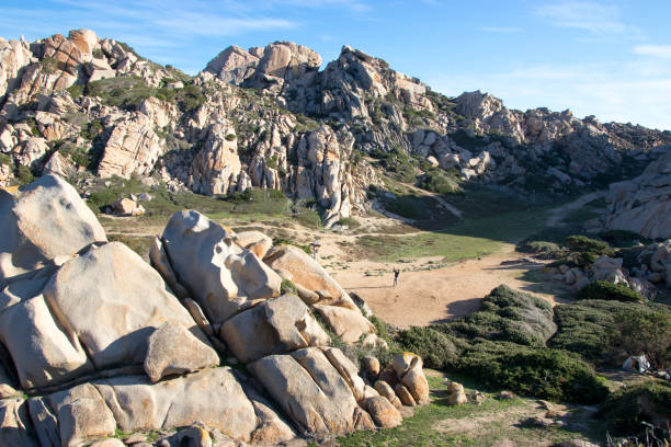 istock Man in the middle of valley with interesting rock formations 904957484