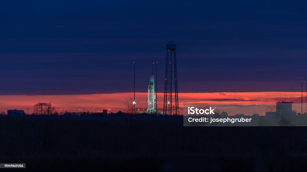 T-1 hours to launch of the Orbital ATK Antares launch vehicle Orbital ATK's Antares launch vehicle sits on launch pad 0 at the Mid-Atlantic Regional Spaceport as dawn breaks on the horizon prior to a launch to re-supply the International Space Station Spaceport Stock Photo
