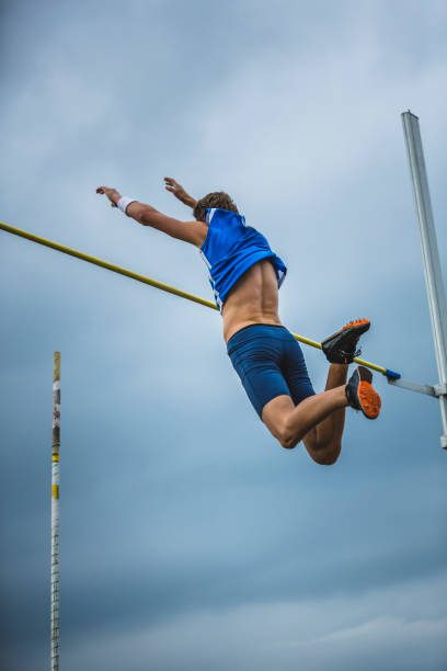 istock Pole vault male athlete successful attempt over bar 904964182