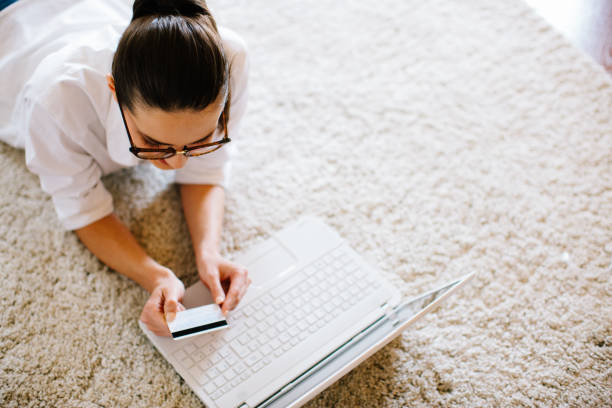 istock Beautiful young woman purchasing online from home 904968736