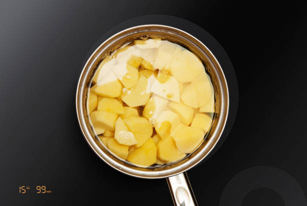 potatoes is cooked in pan stock photo