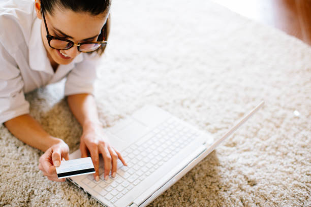 istock Beautiful young woman purchasing online from home 904971482