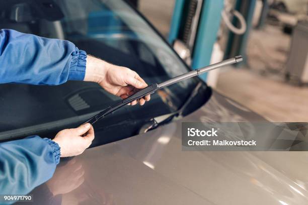 Technician Is Changing Windscreen Wipers On A Car Station Stock Photo - Download Image Now