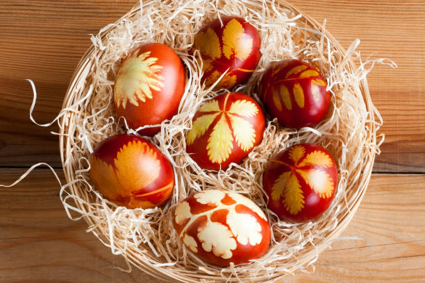 istock Easter egg dyed with onion peels with a pattern of fresh herbs 904979036