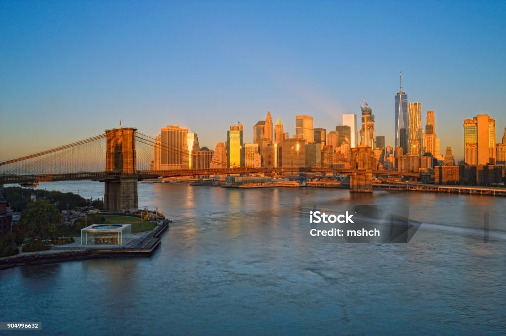 Brooklyn Bridge at sunrise. Manhattan skyline with Brooklyn Bridge at sunrise - HDR image. American Culture Stock Photo