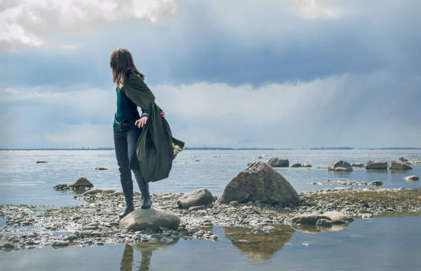 istock Woman on sea shore 905001330