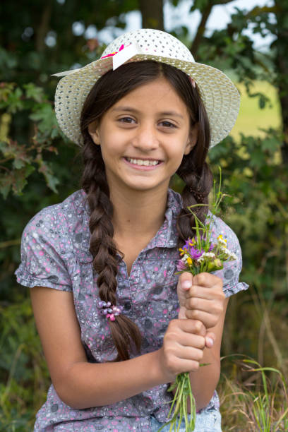 istock Beautiful girl with picked flowers 905008116