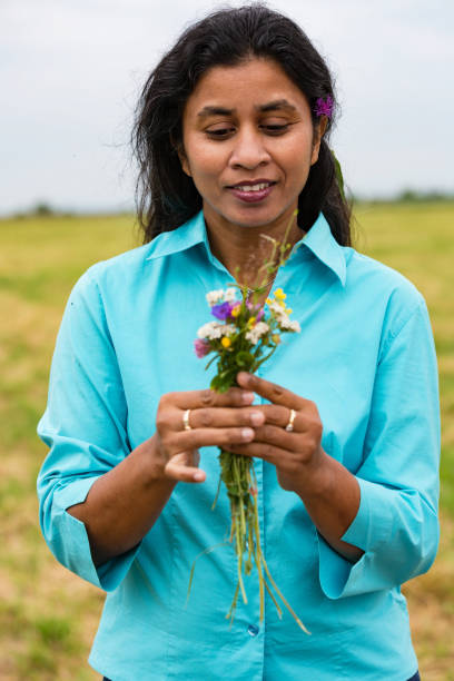 istock Attractive woman with self picked flowers 905010194