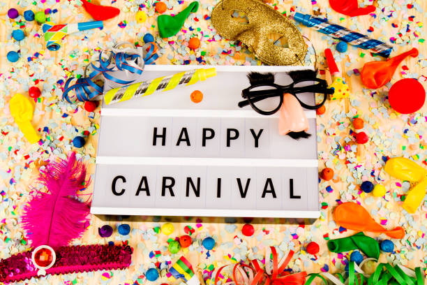 Lightbox with letters - HAPPY CARNEVAL - on colorful festive party decoration with steamers, confetti and ballons.