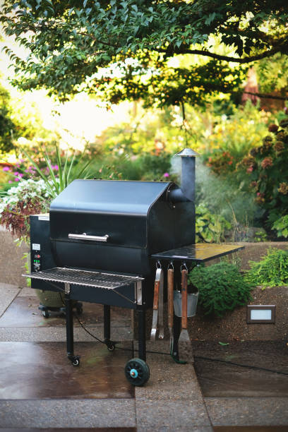 A smoking barbecue grill on a patio in summer