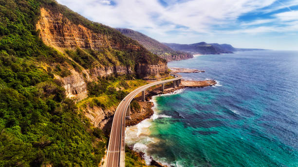 D Sea Cliff Br 2 North Above Sea cliff bridge at the edge of steep sandstone cliff on the Grand Pacific drive along pacific coast of Australia, NSW. Aerial view towards distant hill ranges on sunny summer day. new south wales stock pictures, royalty-free photos & images