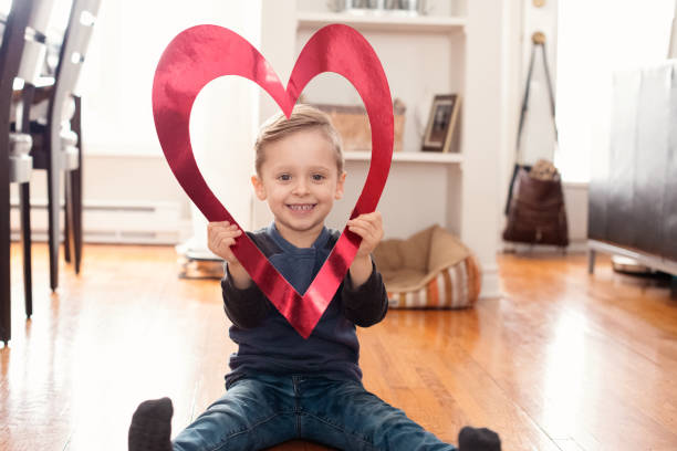 istock Valentine's Day with lovely child holding red heart shape 905027670