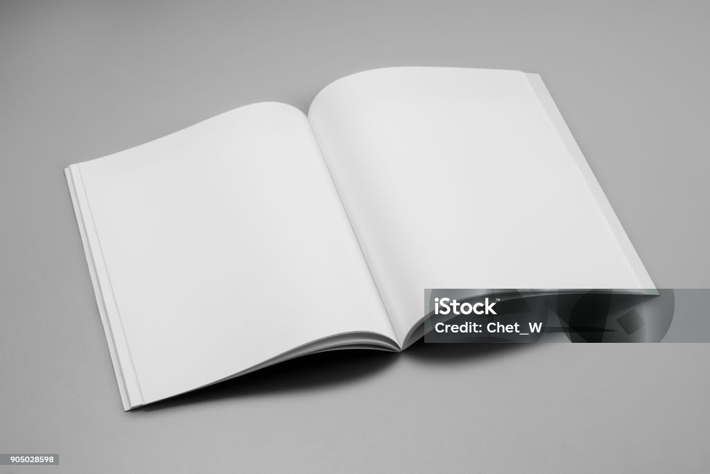 Mock-up magazines, book or catalog on gray table background. Mock-up magazine, book or catalog on gray table. Blank page or notepad on solid background. Blank page or notepad for mockups or simulations. Magazine - Publication Stock Photo