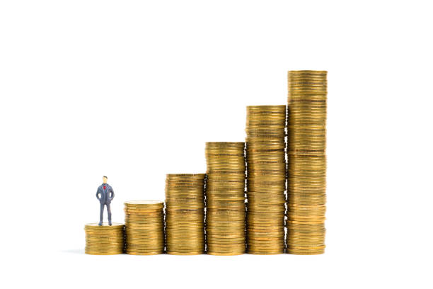istock Figure miniature businessman or small people standing on first step of coin stack, isolated on white background for money and financial business concept. 905028846