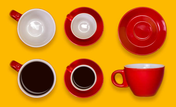 istock Set of empty and full red cups and a saucers. Coffee set on a yellow background 905034436