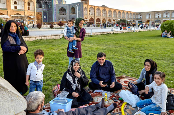 Iranian family is resting of square Naghshe Jahan, Isfahan, Iran. Isfahan, Iran - April 23, 2017: Iranian family make picnicking in the Naghshe Jahan square. iranian ethnicity stock pictures, royalty-free photos & images