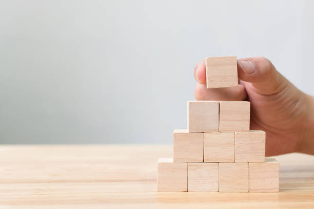 istock Hand arranging wood block stacking as step stair. Business concept for growth success process 905035584